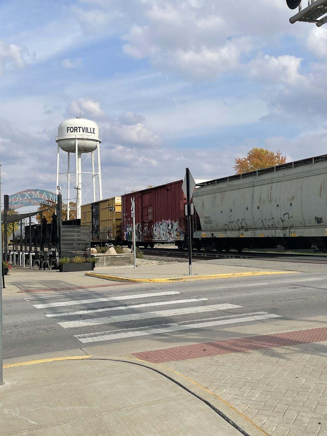 The Fortville water tower with a train passing